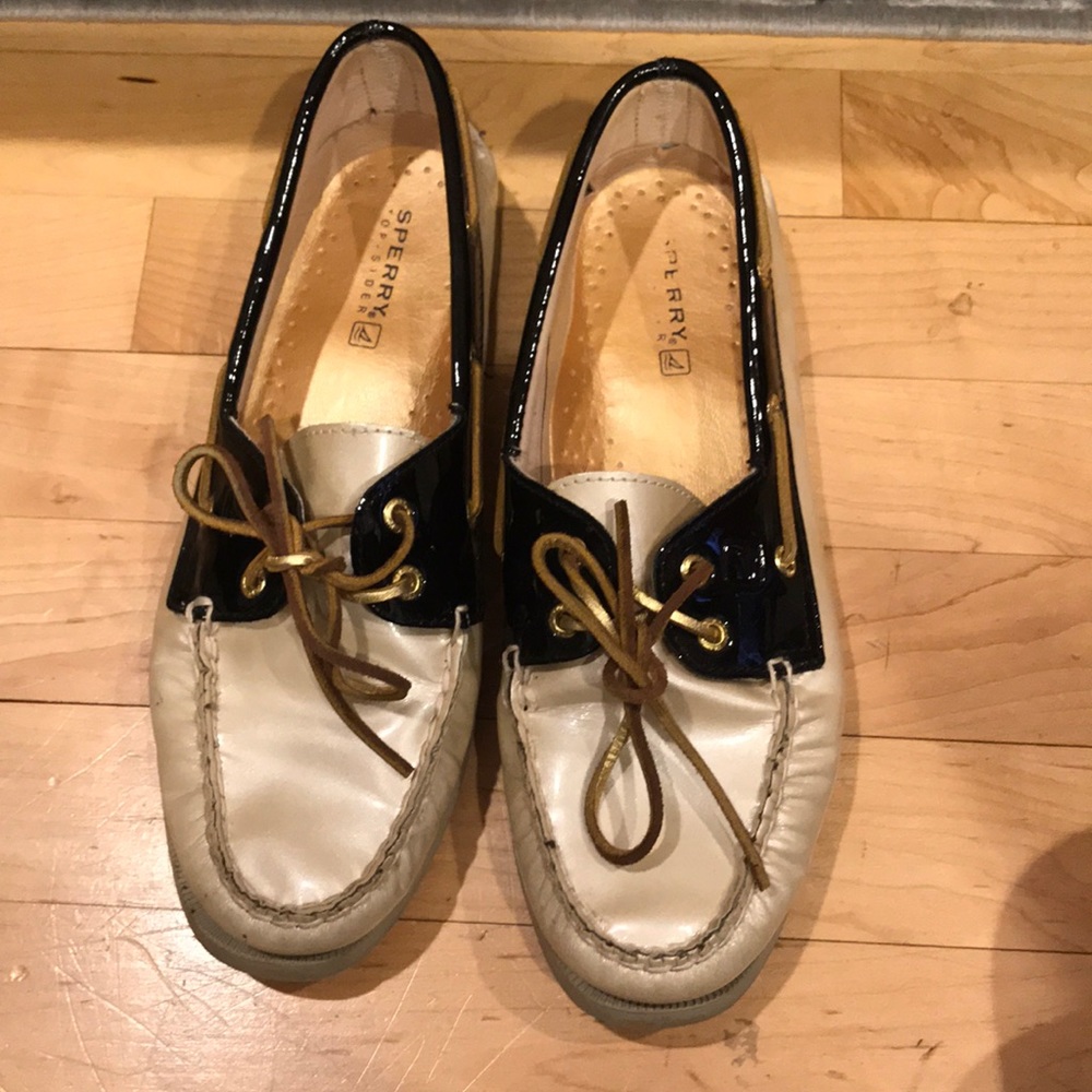 Sperry gold and black patent leather boat shoes.